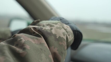Ukrainian military man in uniform and leather gloves drives a car, close-up. transportation in the army. the use of pickup trucks for military purposes. military evacuation