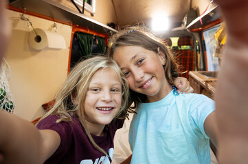 Happy children take a self on a wonderful day at camp. Van life concept.