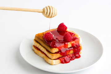 Toast bread with raspberry jam on plate