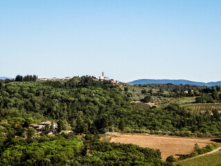 Hills, meadows and vineyards, Tuscan village, Italy