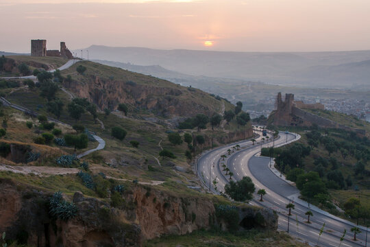 The sun rises over the scenery and city of Fes; Fes, Morocco