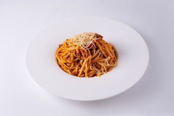 pasta in sauce with cheese on a white background