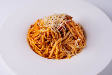 pasta in sauce with cheese on a white background