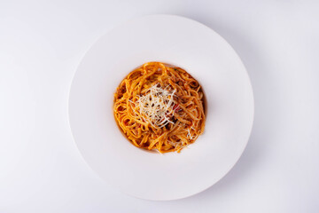 pasta in sauce with cheese on a white background