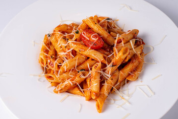 macaroni in sauce with cheese on a white background