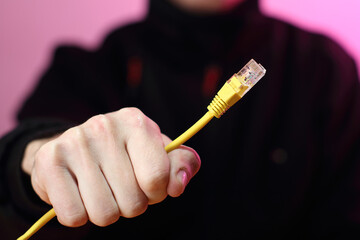 yellow ethernet cable in hand