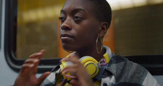 Young Black Woman With Headphones in Subway