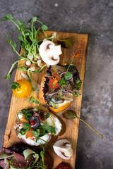 top view assorted bruschetta with different flavors on a wooden board