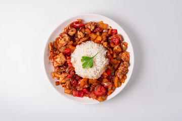 stewed vegetables with meat and boiled rice. on a white background