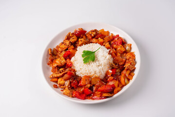 stewed vegetables with meat and boiled rice. on a white background