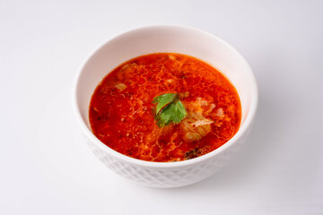 red soup with meat on a white background