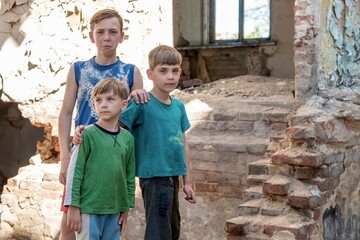 Children in an abandoned and destroyed building in the zone of military and military conflicts. The...