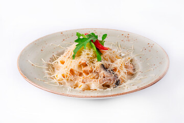 pasta with mushrooms, chicken meat, sprinkled with cheese on a white background