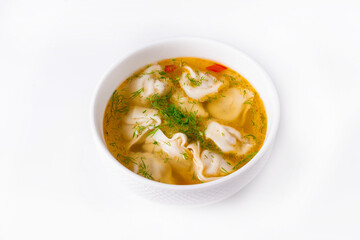 dumplings with broth on a white background
