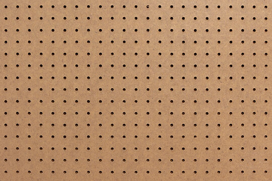 Abstract background of brown perforated hardboard sheet, Plywood with pre-drilled with evenly spaced holes Nature seamless pattern texture, Surface and details of brown wood plank.
