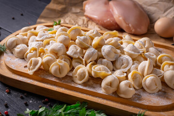 semi-finished products, dumplings with minced chicken, on a black background