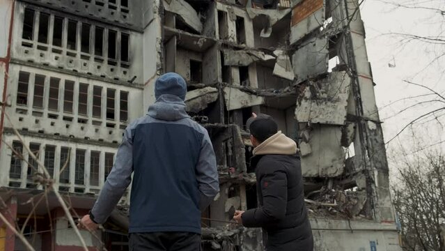 Ukraine. Kharkov. War. People walking among the ruined civill building. Russian aggression. Victims of Russian military aggression.
