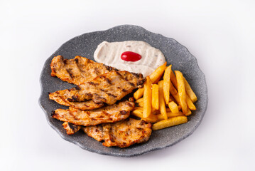 chicken steak with sauce and French fries. on a white background