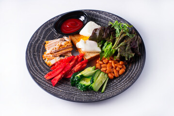 breakfast of chicken meat, tomatoes and cucumbers, beans, bread and sauce on a white background
