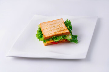 sandwich with vegetables and cheese on a white background