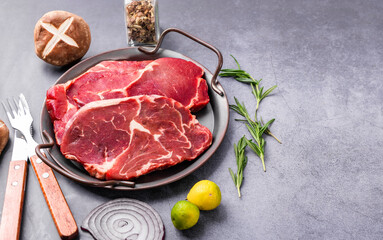 Fresh beef steak on a concrete background