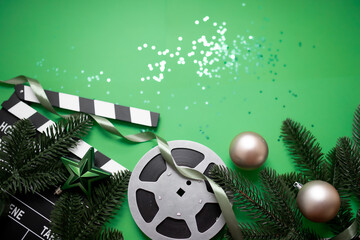 
christmas movie night concept. New Year's decorations, film reel, clapperboard and confetti...