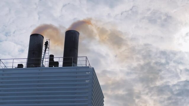 Cruise ship with smoking chimney. Yellow sulphurous smoke rises from the chimney