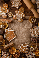 Christmas ginger cookies. Still life on a table with a rolling pin, cloves, dried citrus, pine nuts and cones and kraft paper