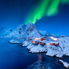 Aurora Borealis. Northern Lights. View on the house in the Hamnoy village, Lofoten Islands, Norway....