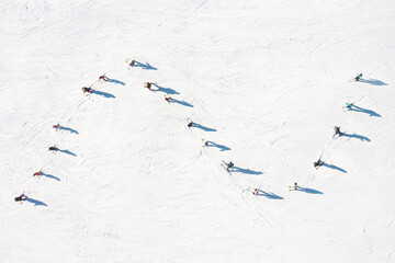 Ski resort. An aerial view of the ski team. Winter sports. Snow slope in the mountains for sports....