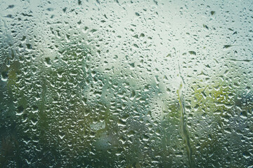 Drops on glass after rain. Autumn weather outside window. Rain outside window.