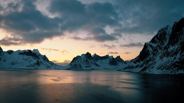 Sunset over the lofoten mountains,4k drone shot of norwegian fjords,Sunset scenery in Norway, scandinavian mountains, Norwegian nature, Picturesque,lofoten islands,snowy mountains, Reine,norwegian sea