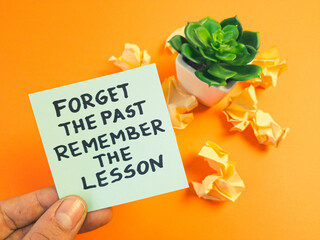 Motivational and inspirational quote - forget the past, remember the lesson handwritten on sticky note. Positive thinking, motivation, self development concept