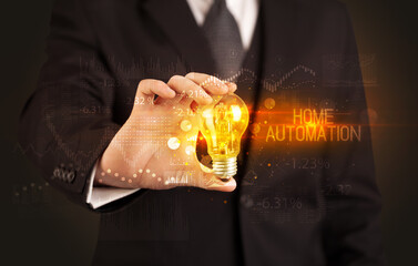 Businessman holding a lightbulb concept