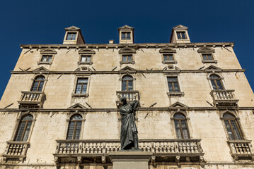Statue of Marko Marulic, father of Croatian literature, by Ivan Mestrovic in front of the Milesi Palace in Fruit Square; Split, Croatia