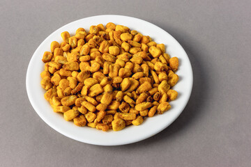 Roasted corn kernels on a gray background