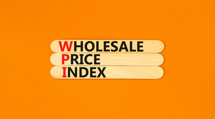 WPI wholesale price index symbol. Concept words WPI wholesale price index on wooden sticks on beautiful orange table orange background. Business WPI wholesale price index concept. Copy space.