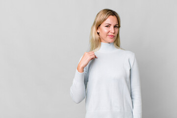 caucasian blonde woman looking arrogant, successful, positive and proud. copy space concept