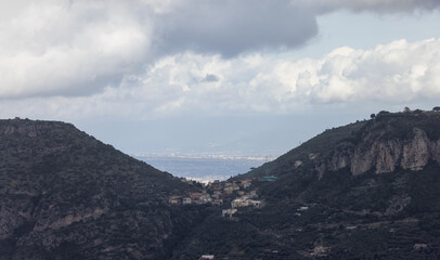 Obraz premium Residential Homes on top of Mountain by the Sea. Near Touristic Town of Sorrento, Italy. Cloudy Day.