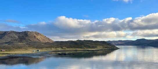 Naklejka na ściany i meble Reflection of blue sky with mountains on lake in Norway 