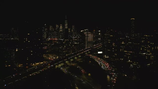 Aerial footage of busy multilane roads at rush hour. Night city scene with skyscrapers in background. New York City, USA