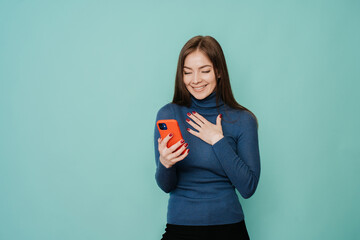 Grateful italian young woman looks at phone with amazed face expression, received unexpected news...