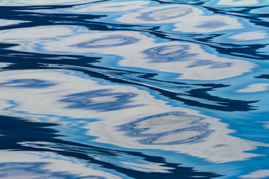 Reflections on the surface of water creating a pattern in tones of blue, Inside Passage, Great Bear Rainforest; British Columbia, Canada