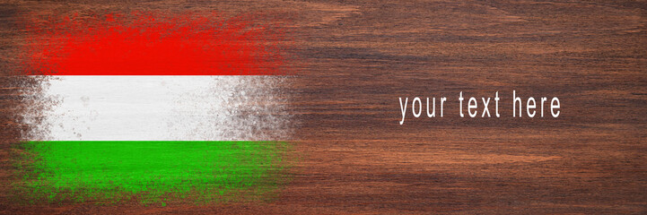 Flag of Hungary. Flag is painted on a wooden surface. Wooden background. Plywood surface. Copy space. Textured background