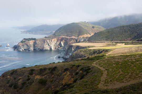 Clouds over the California coast, beaches, rock formations and the Pacific Coast Highway, near Bixby Bridge.; Pacific Coast Highway, California