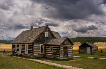 Fototapeta na wymiar Log Cabins in the Colorado High Country Beneath Stormy Skies