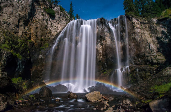 Stunning, Dunanda Falls at night with a lunar rainbow along the Boundary Creek Trail in Yellowstone National Park; Wyoming, United States of America