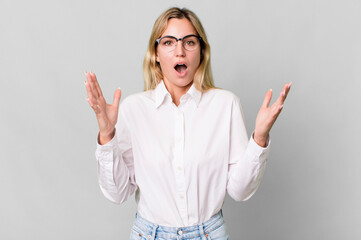 caucasian blonde woman amazed, shocked and astonished with an unbelievable surprise