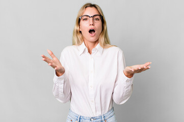 caucasian blonde woman feeling extremely shocked and surprised