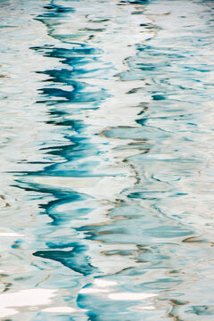 Abstract patterns on a watery surface with icy and wavy reflections; South Georgia Island, Antarctica